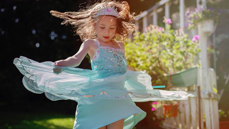 Girl dressed as princess spinning