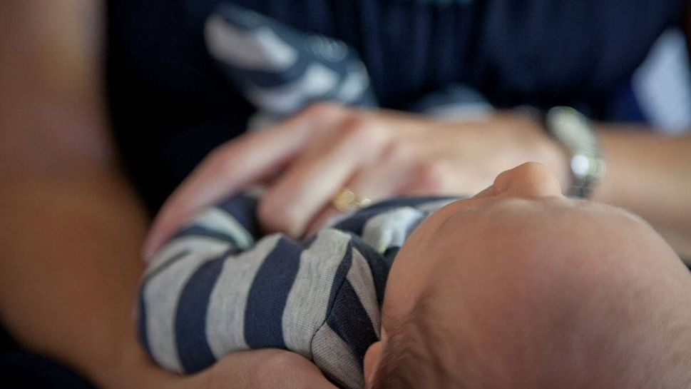 woman holding newborn baby