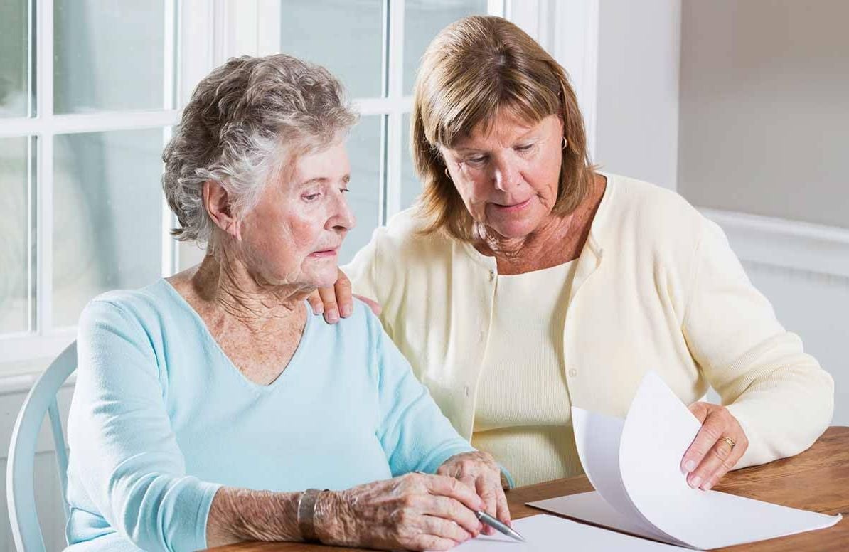 Woman reviewing paperwork with mother