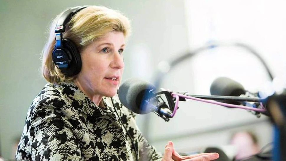 NPR's Nina Totenberg wearing headphones and in front of a microphone