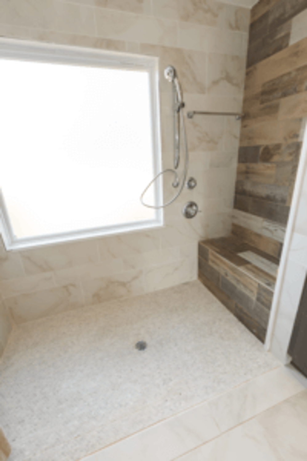 The curbless shower is easy to step or roll into and features a bench for sitting.