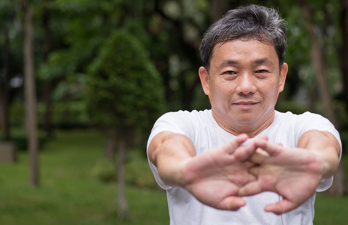 Woman stretching arms for good flexibility of her bicep stock