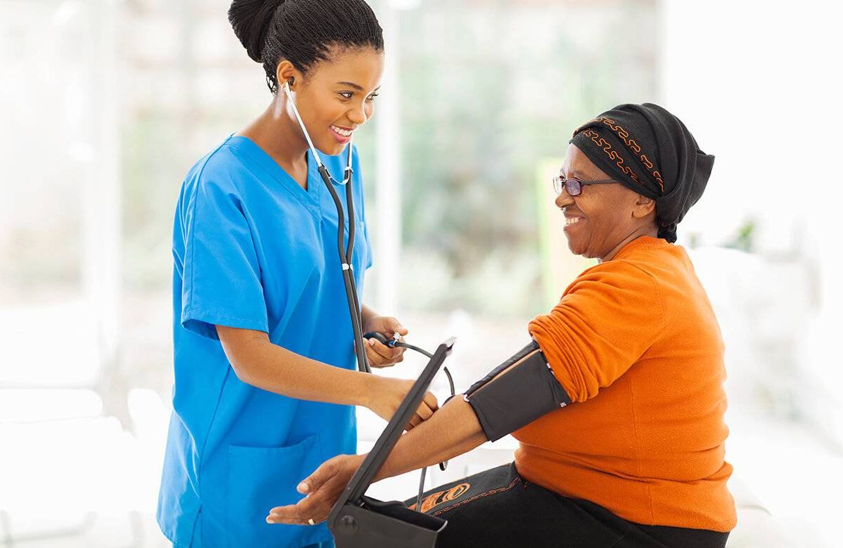 a nurse takes a patient's blood pressure