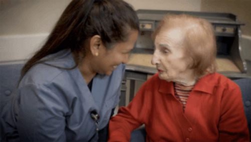 Staff member with a resident of United Hebrew’s Memory Care Community, Willow Gardens Memory Care