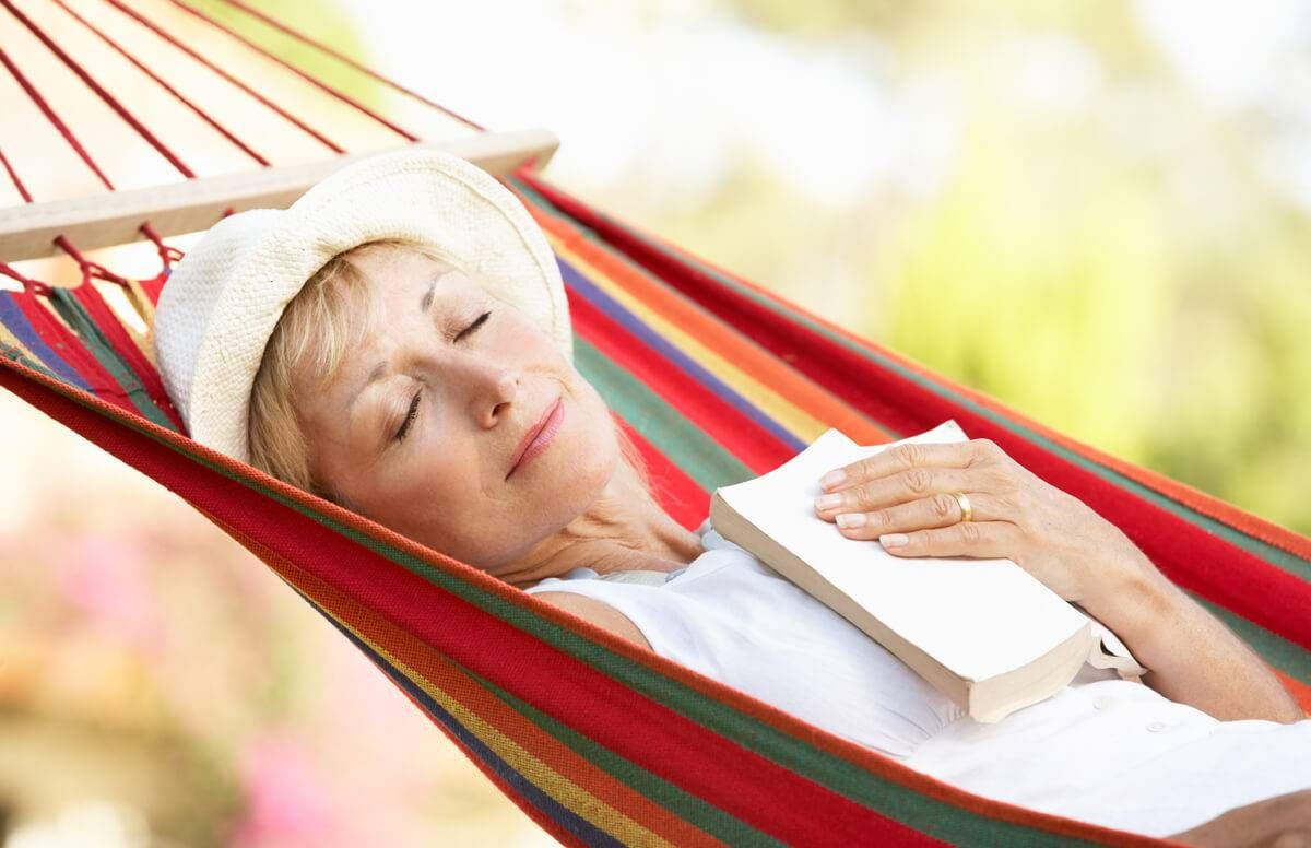 Senior Woman Relaxing In Hammock