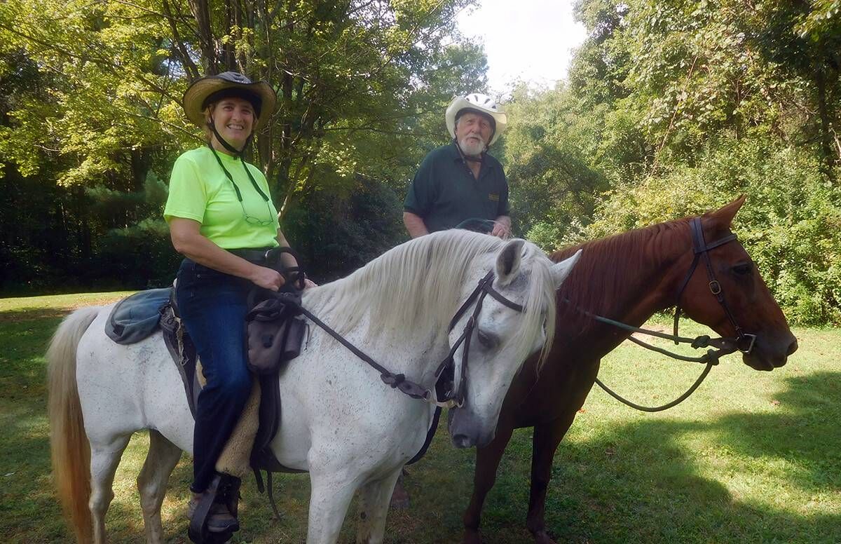 Jeanette and Roy Henderson take a break during a ride with their horses.