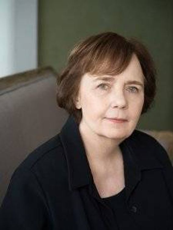 headshot of woman with short brown hair softly smiling