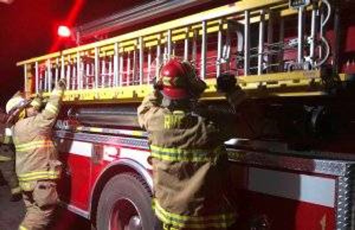 Members of the Rensselaerville (N.Y.) Volunteer Fire Department deploy a ladder during a chimney-fire drill.