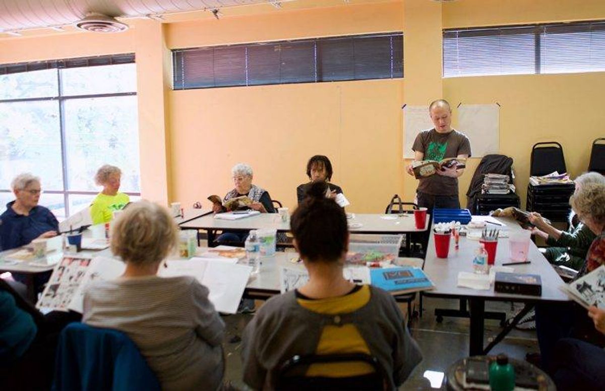 Teaching artist Masanari Kawahara (standing) leads a discussion on visual imagery