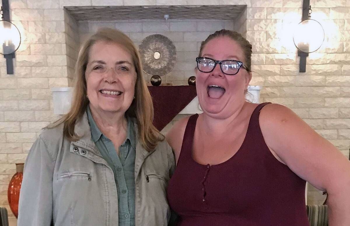 Carmen Saperstein, left, 70, who has Alzheimer’s disease, poses with professional comedian Angela Dirksen of Laughter On Call in Los Angeles.