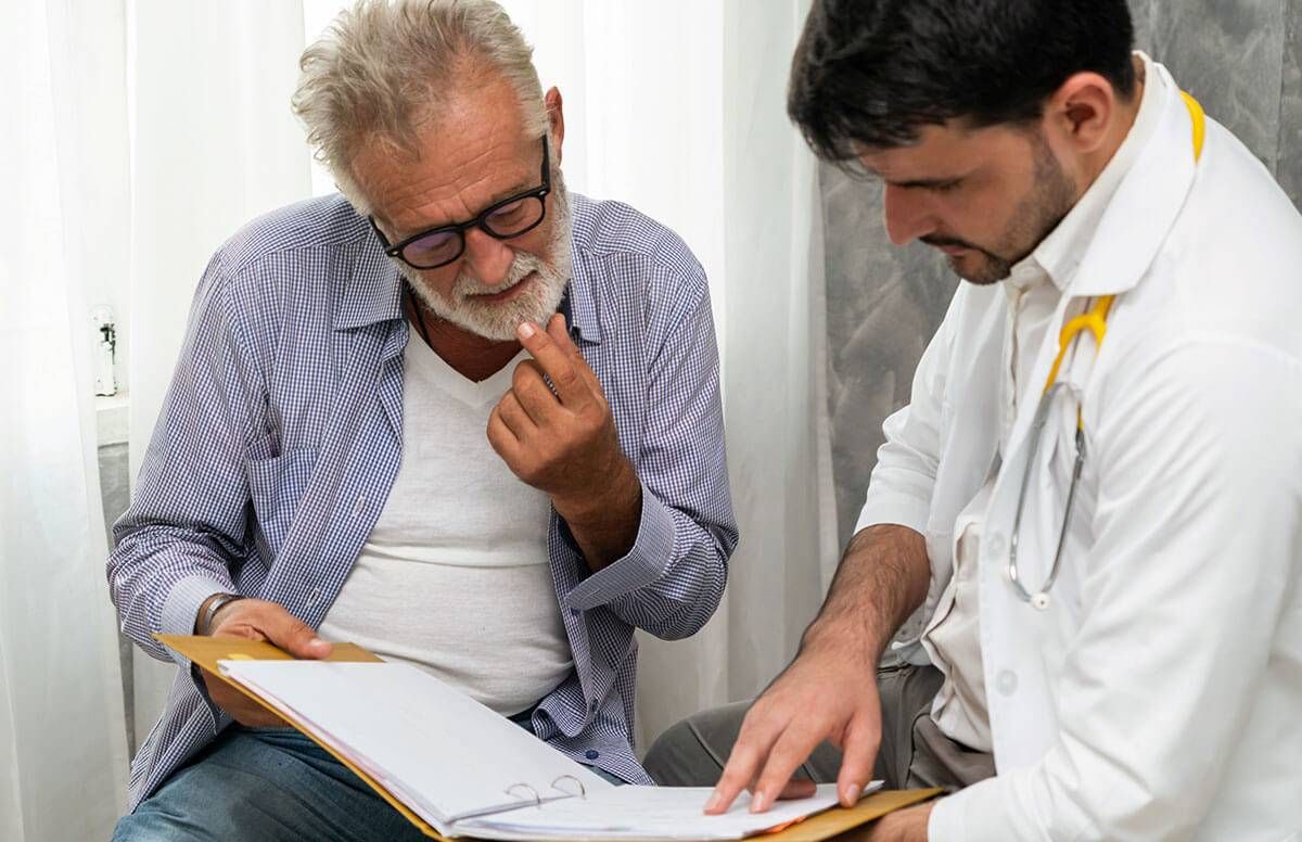 middle aged man discussing test results with doctor