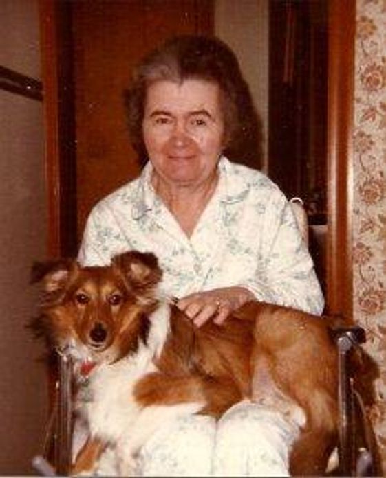 the writer's mother with the family's dog, Penny, on her lap