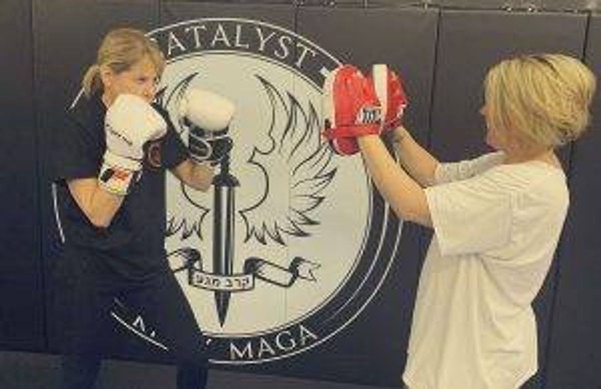 Lisa Kanarek (left) does some punching training with fellow Krav Maga student Kendra Hernandez.