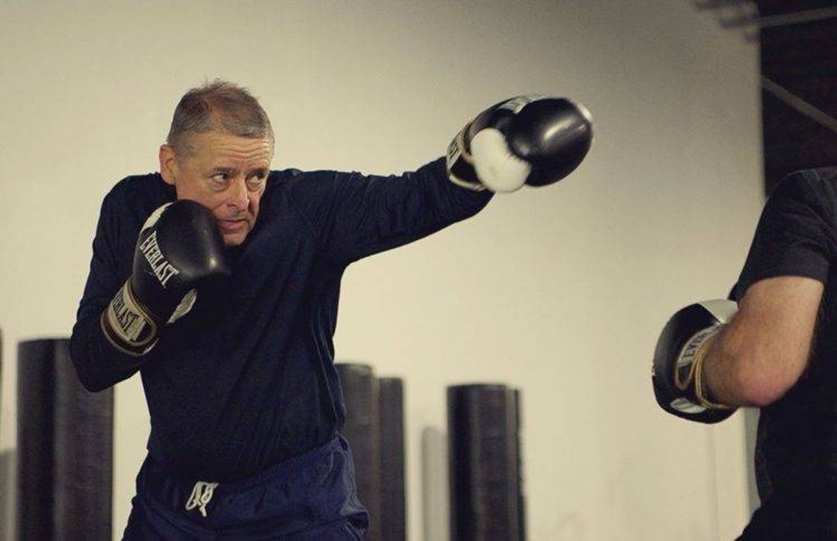 Steve Johnson (left) shows intense focus while practicing punches with fellow boxing student Tom Ryan.