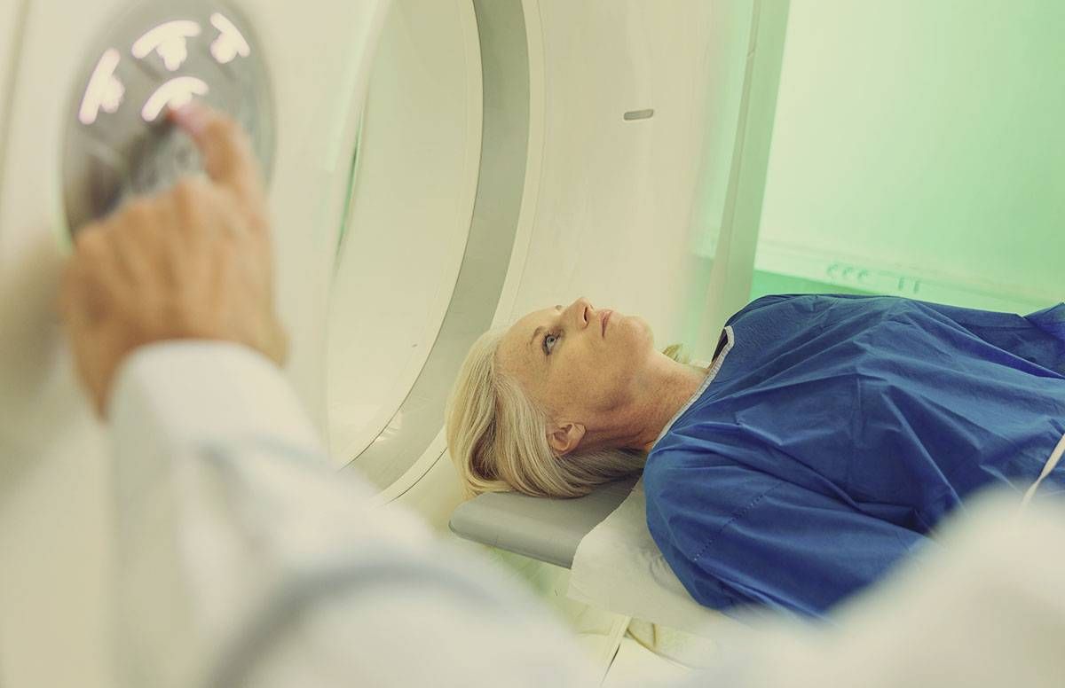 a woman entering an MRI machine