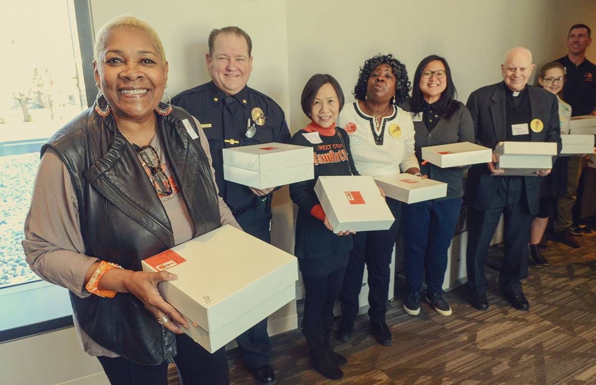 Preparing to march in with 90 pies during the 2018 MLK event at Brookview Community Center in Golden Valley, Minn. Standing next to Rose McGee is Jason Sturgis, police chief in Golden Valley.