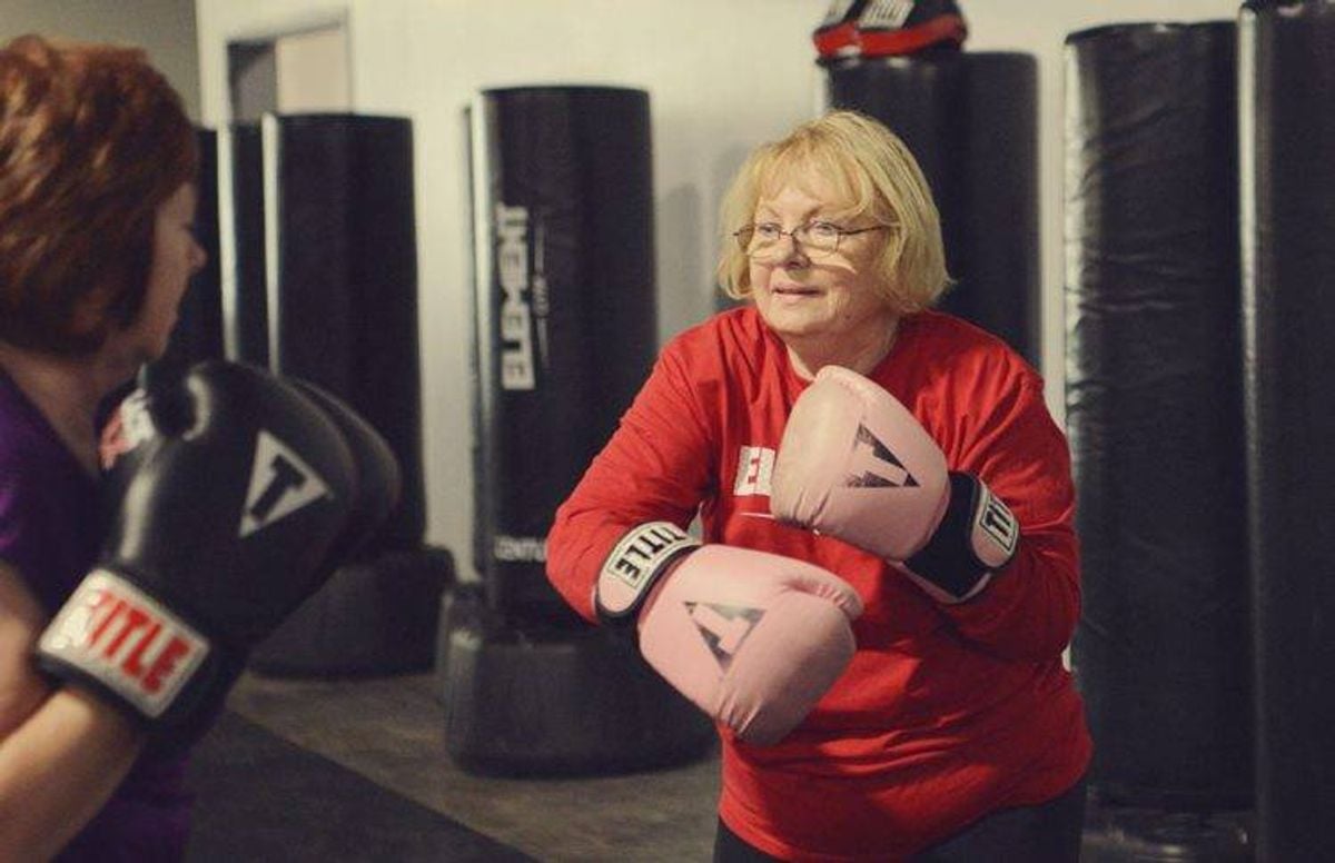 Bette Forster (right) practices a hook punch with fellow student Vicky Stanich.