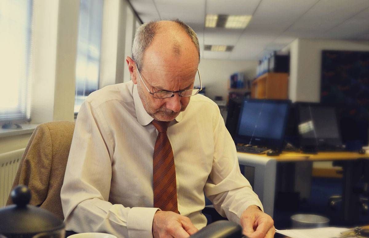 middle aged man working in an office