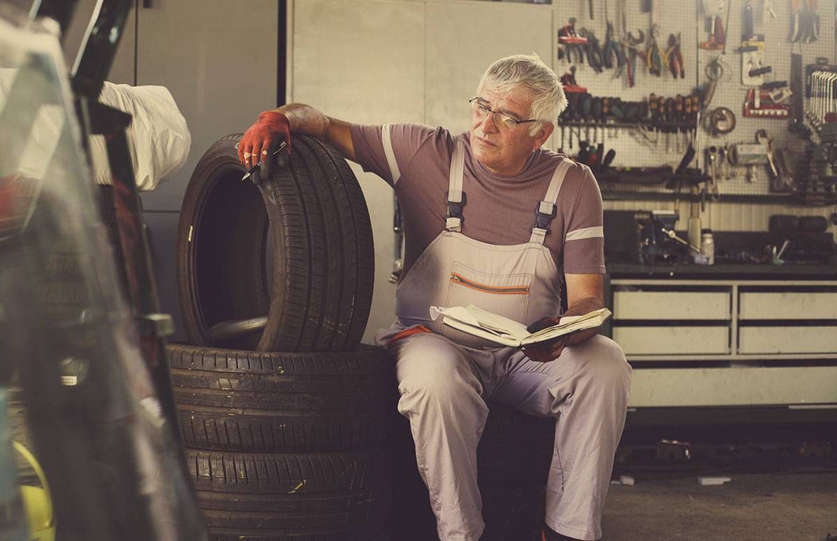 A middle-aged man running his small business repairing vehicles