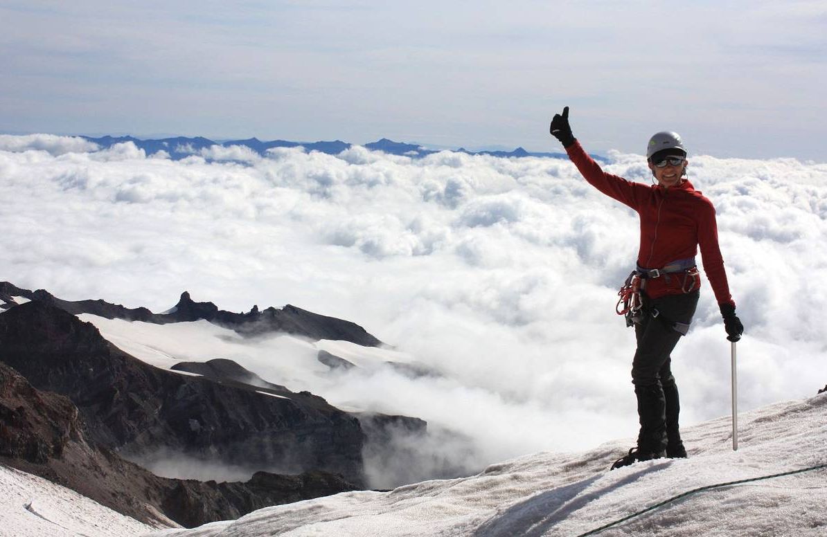 Joy Rikala celebrates her climb above the clouds on Mount Rainier in Washington