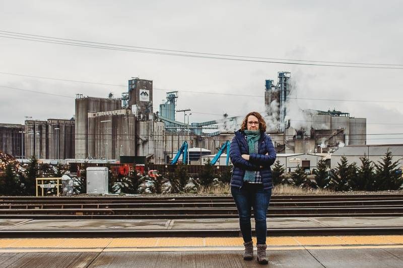 Linda Garcia standing in front of the Tesoro Savage Terminal at Port Washington.