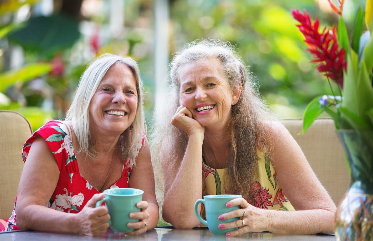 Older couple enjoying coffee in the sunshine,