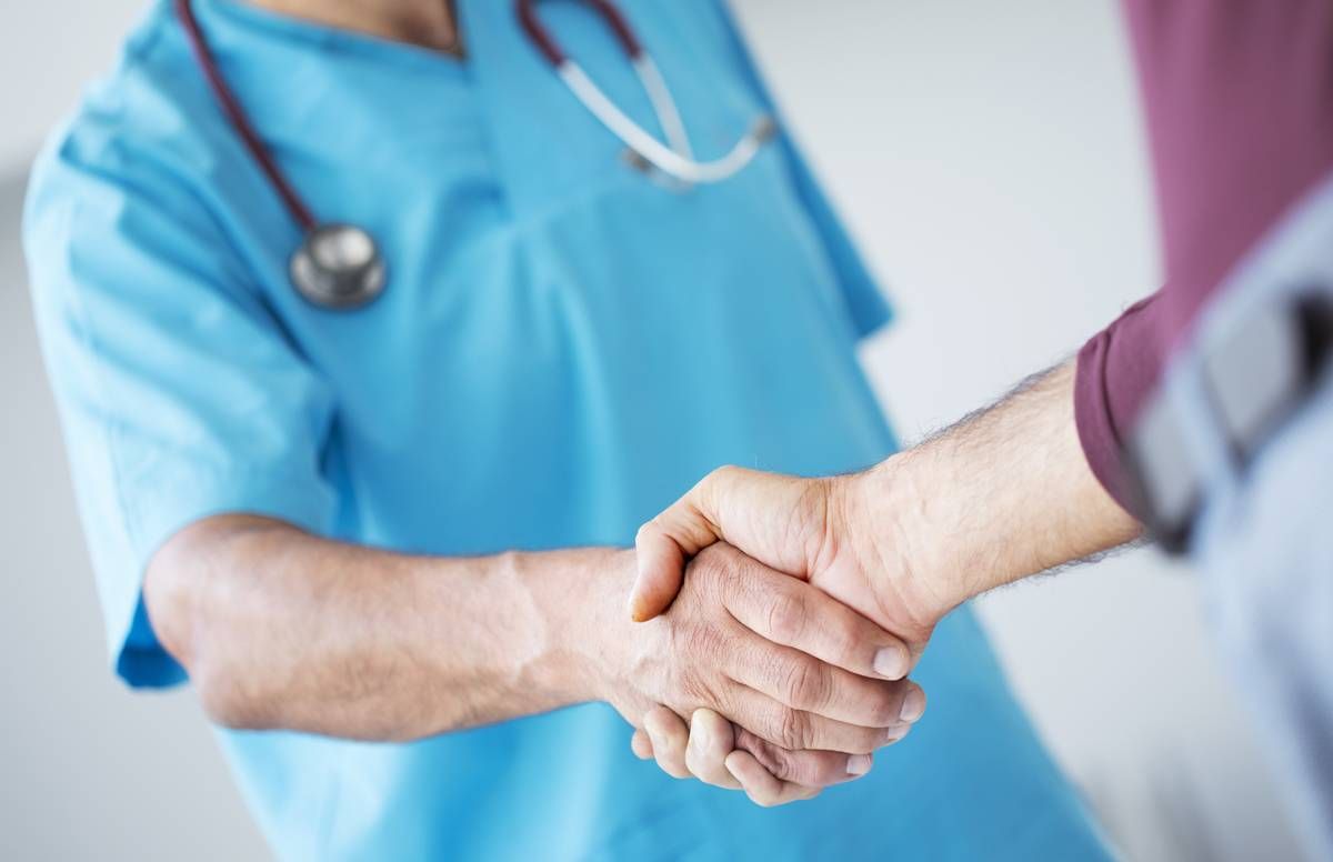 doctor shaking hands with patient