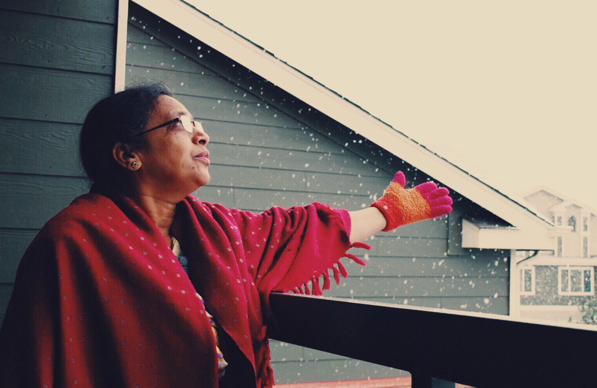 Woman touching snow on a patio