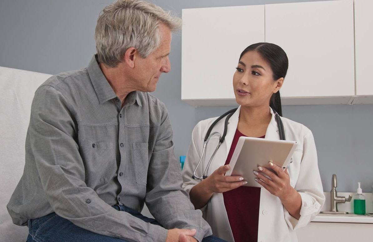 Patient conversing with primary care doctor.