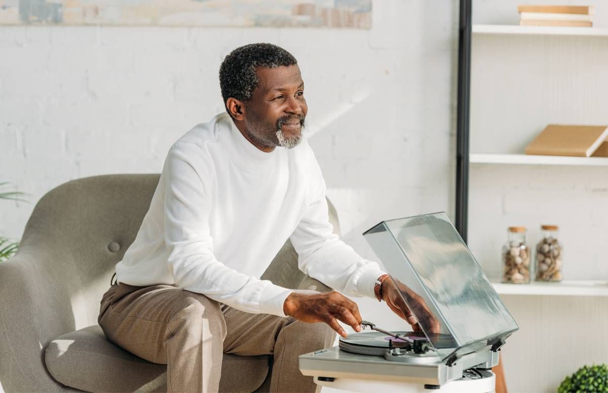 man playing records