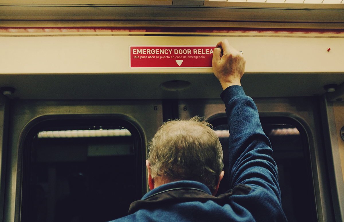 a middle aged man preparing to exit public transportation