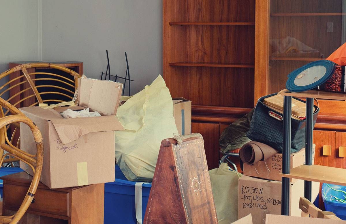 items in boxes, old furniture and clutter in someone's home