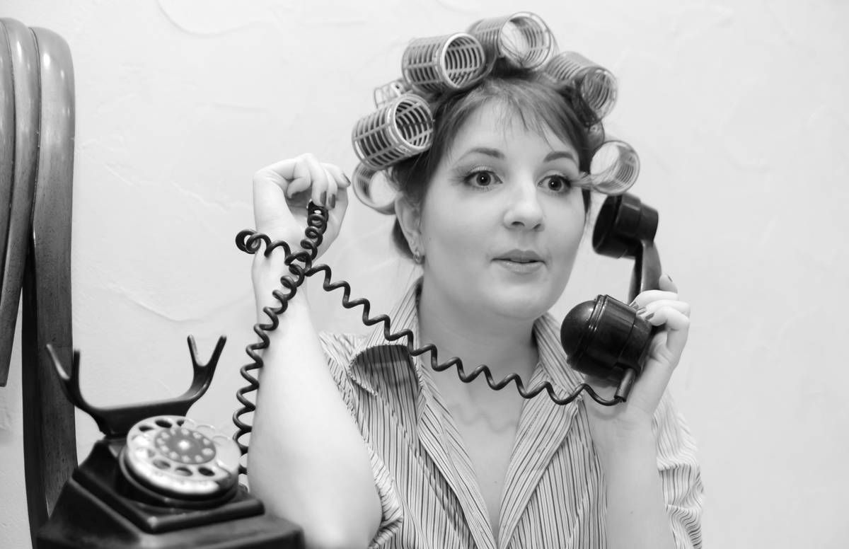 woman in curlers on phone