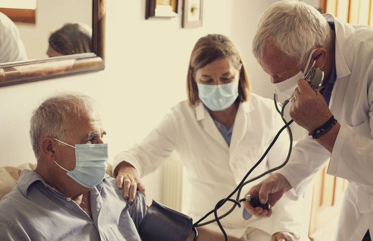 a middle aged man receives medical care in his home