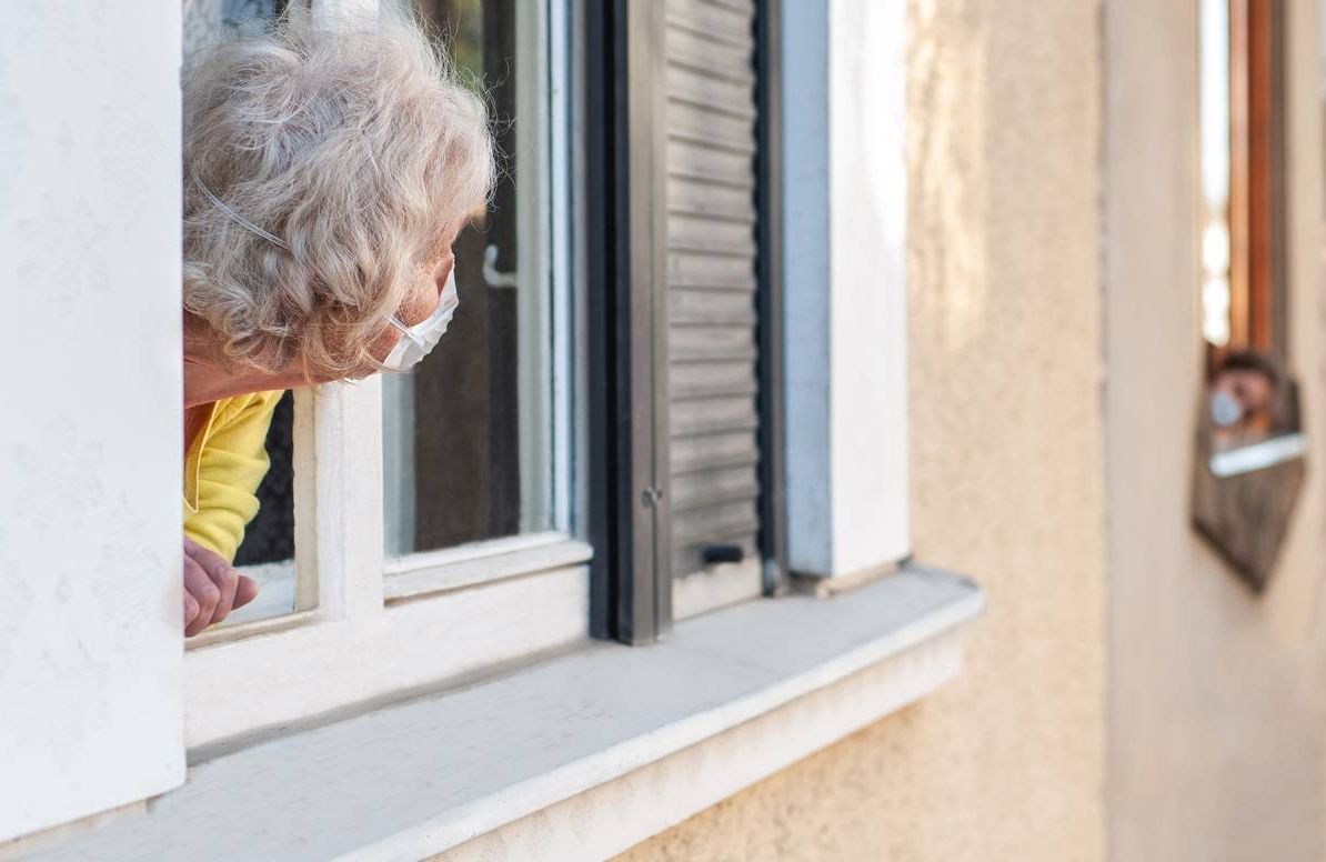 older person leaning out of window