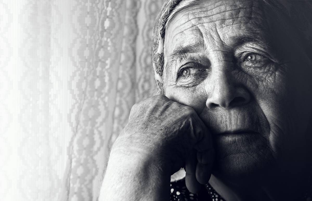 Older woman looking out window