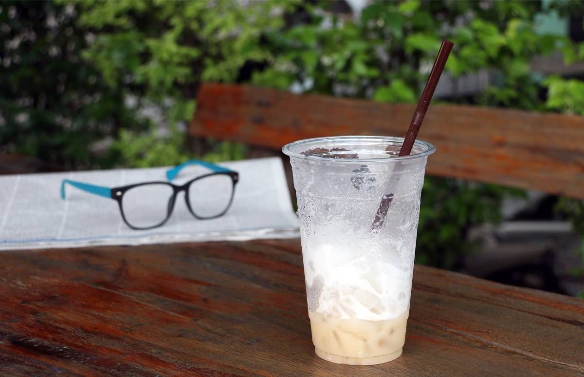 latte and a pair of glasses on a table