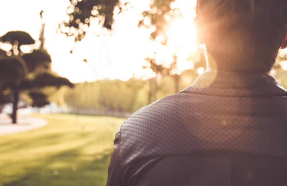 man seated in the sunlight