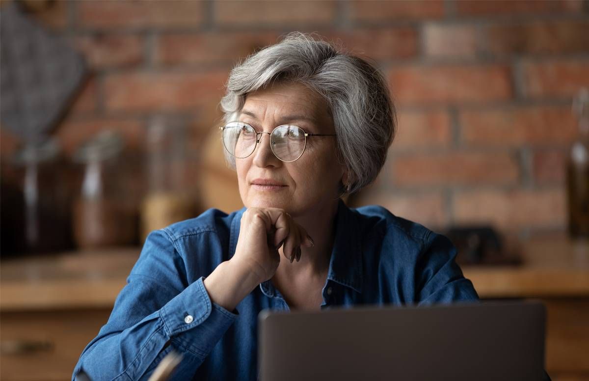 woman looking pensive at computer