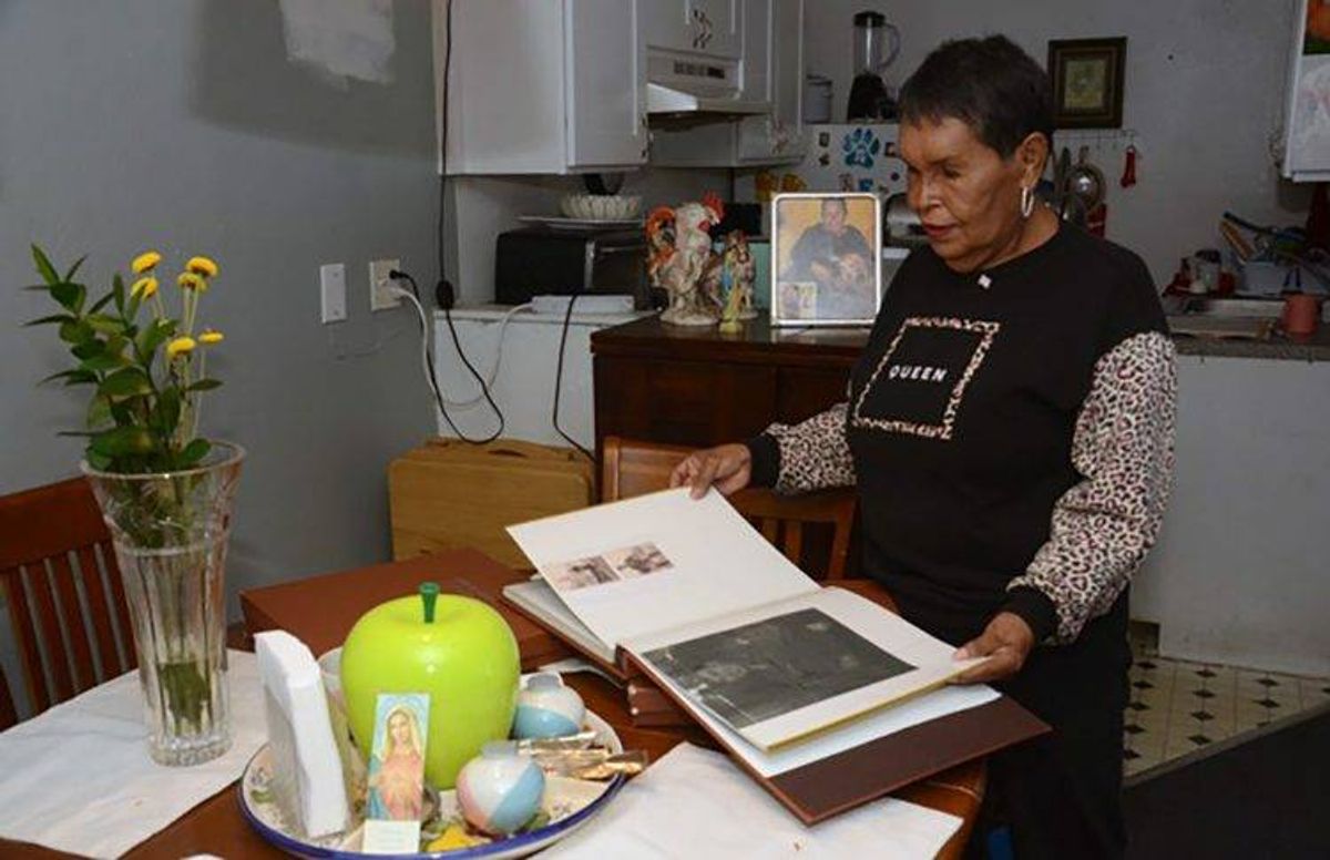 Felicia Elizondo looks through scrapbooks in her home