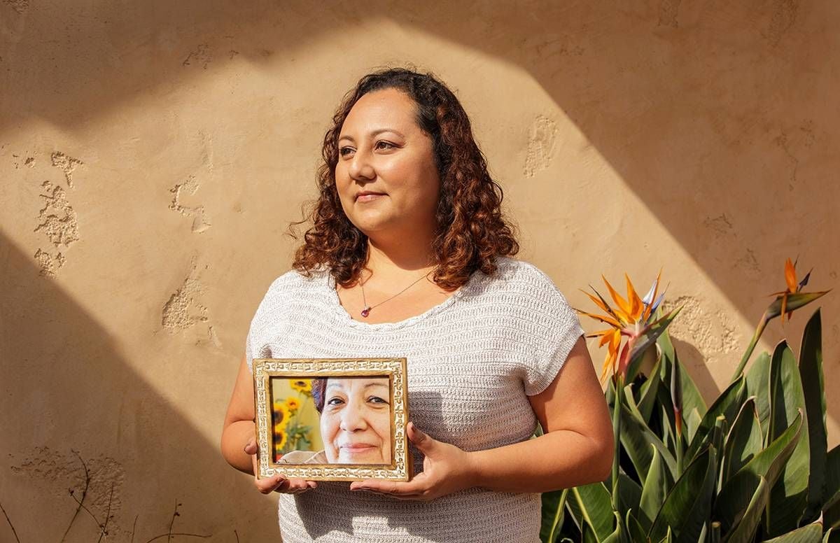 Michelle Rios holds a photo of her late mother Maria Elena Nuñez.