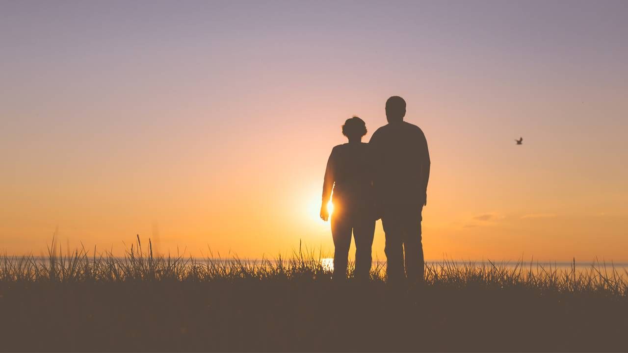 couple watching the sunset in shadow, end a marriage, next avenue