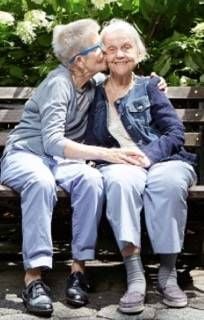 Cindy kissing Helen's face on a park bench