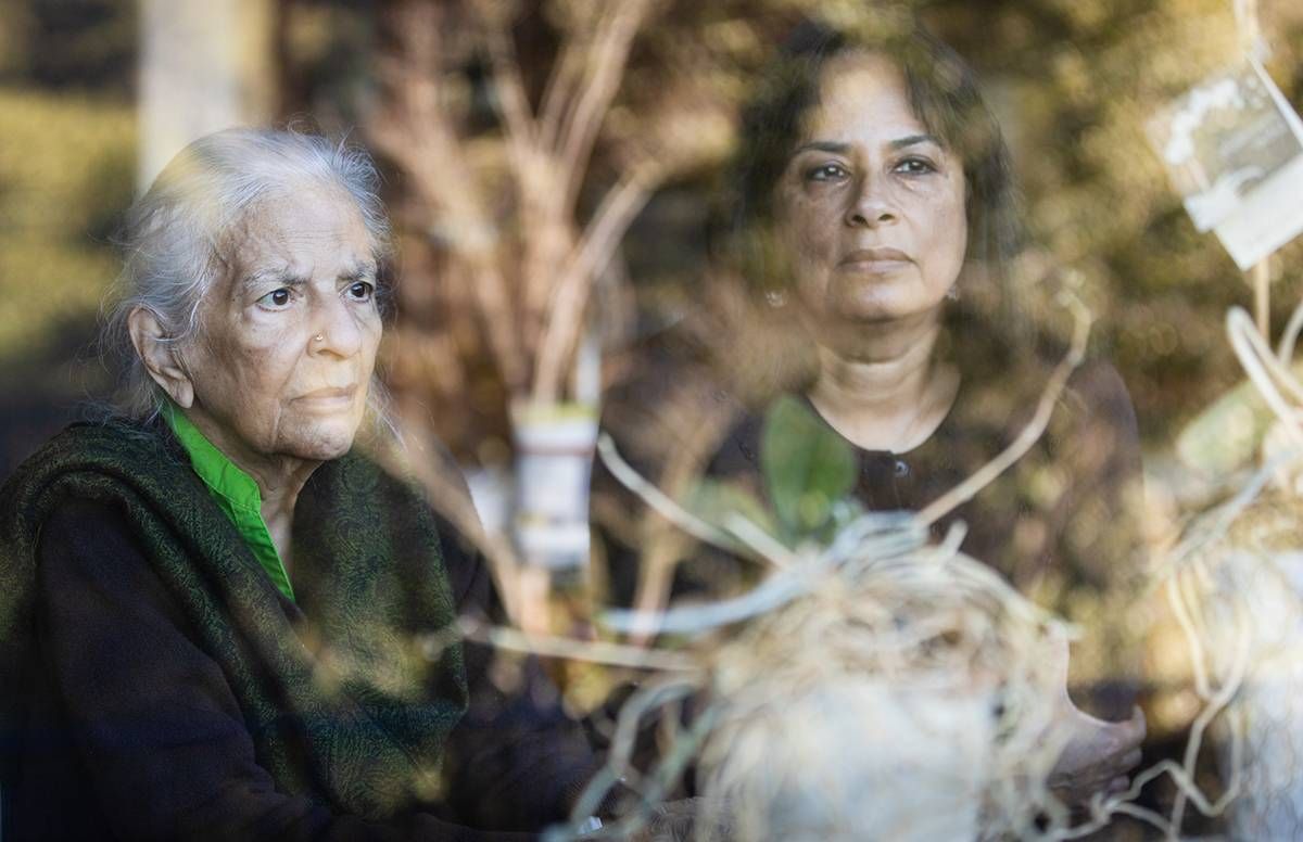 Jaya Padmanabhan (right), her mother, Sarada Ramachandran, and the orchids at their home in Los Altos Hills, CA, on Sunday, December 20, 2020.