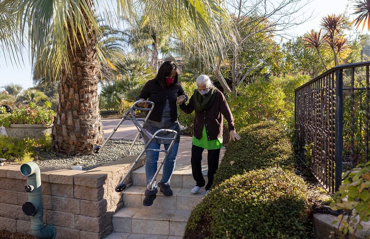 The author Jaya Padmanabhan helps her mother down at their home in Los Altos Hills, Calif., care, caregiving, next avenue