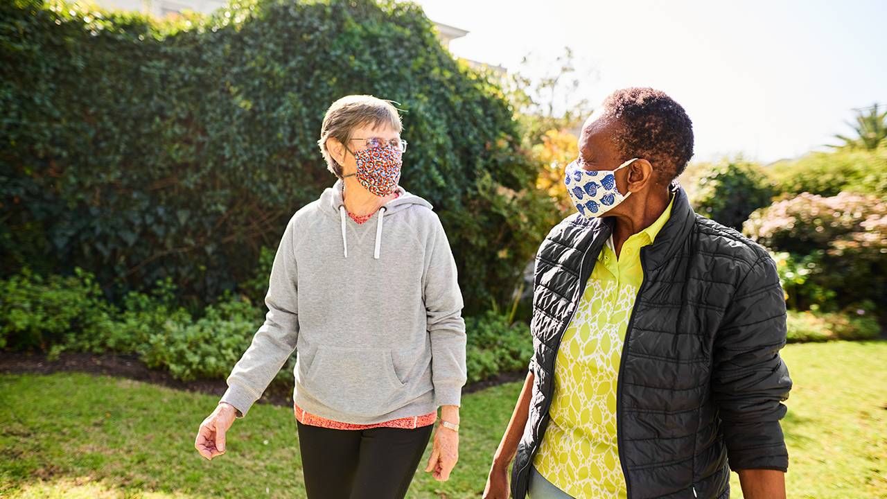 Two friends walking wearing face masks, friendship, Zoom fatigue, Next Avenue