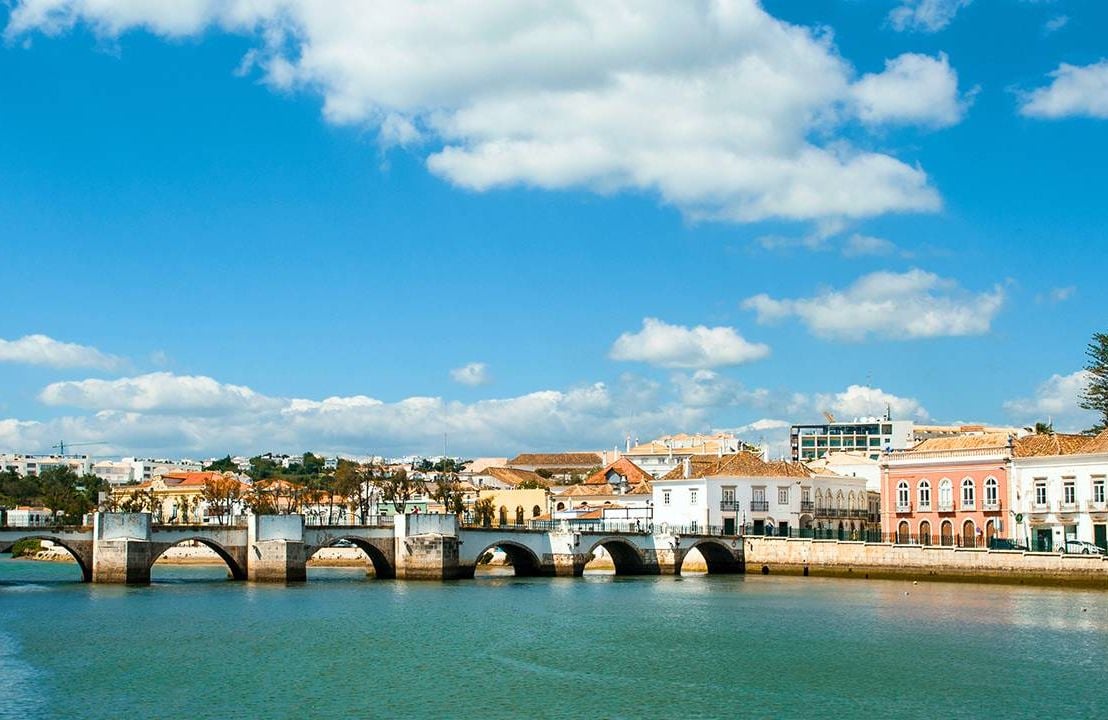 Bridge over water and buildings of Tavira, Portugal, retire abroad