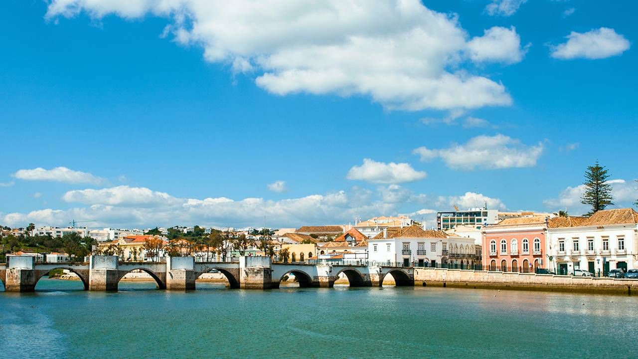 Bridge over water and buildings of Tavira, Portugal, retire abroad