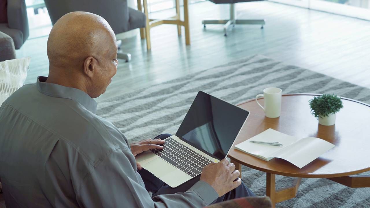 Man working from home, what older workers need on his laptop