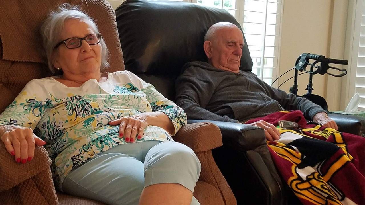 Older couple sitting down in chairs